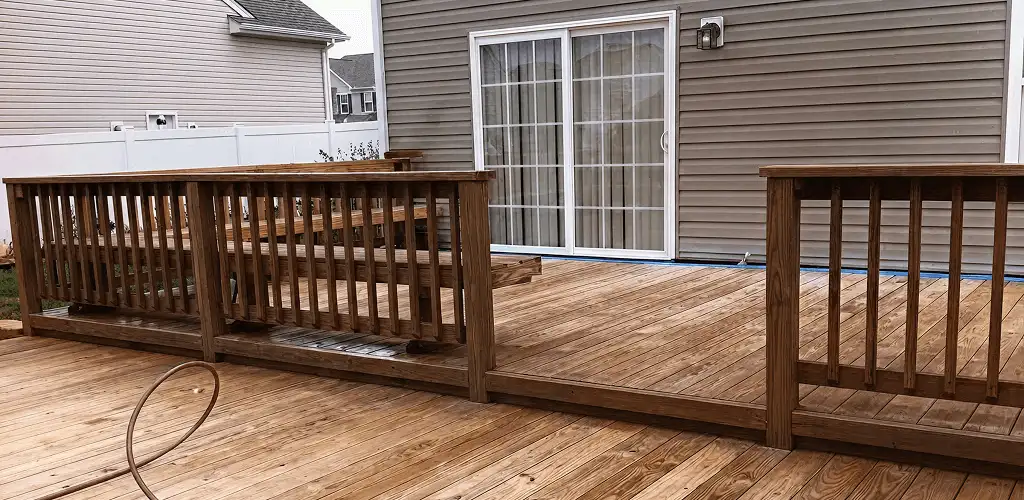 Deck sealing service protecting a backyard wood deck and railings in Dover, DE