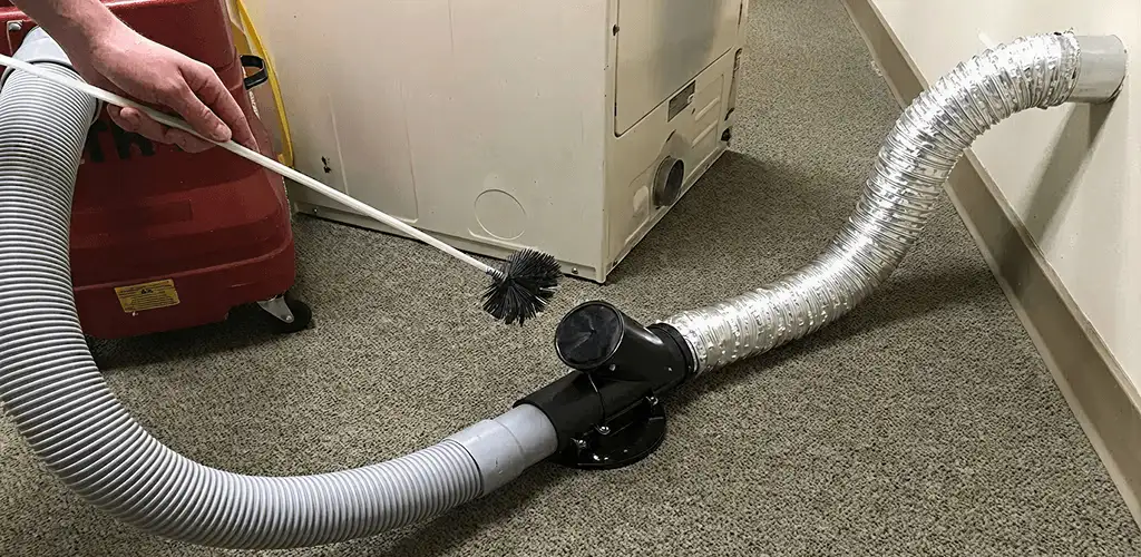 Dryer vent cleaning service removing lint from a dryer duct connection in Dover, DE