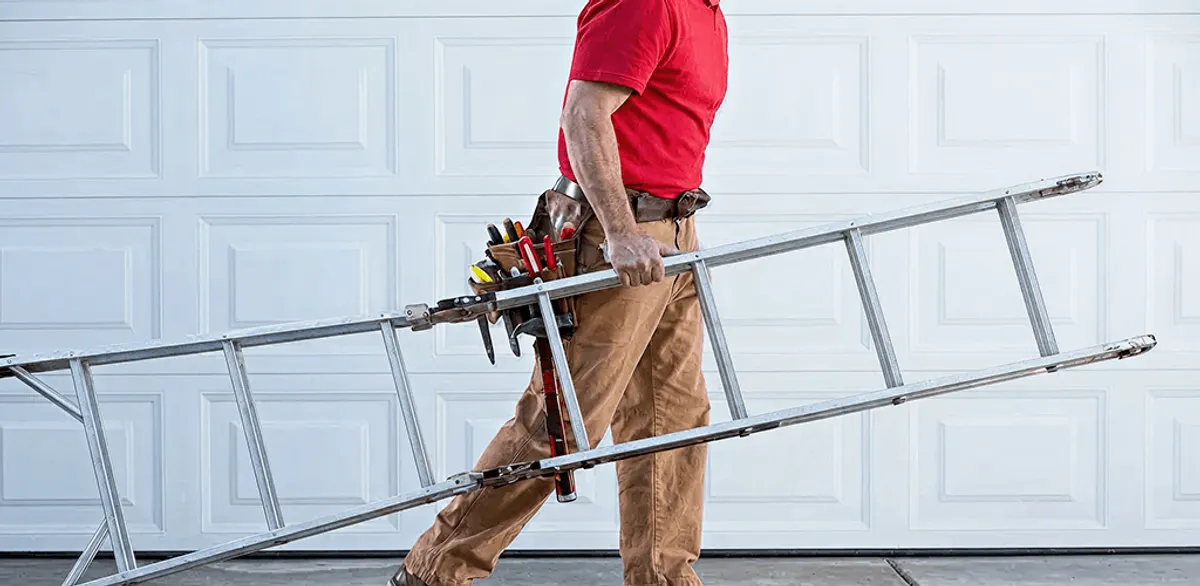 Garage door repair technician arriving with tools and ladder in Dover, DE
