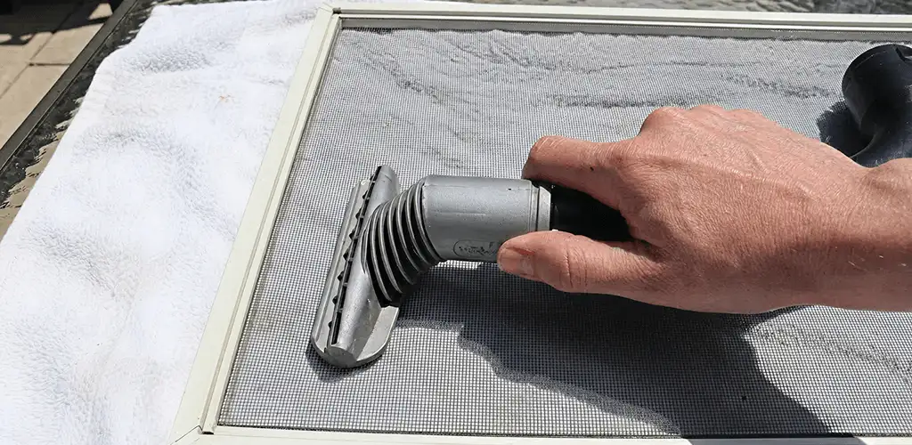 Window screen repair cleaning and fixing a damaged screen mesh in Dover, DE